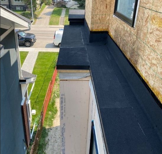 Newly installed torch-on roofing membrane on modern residential structure