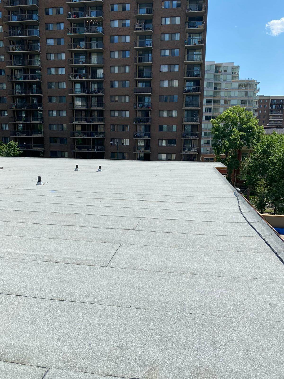 Extensive flat roof repair project with damaged membrane being restored in Calgary