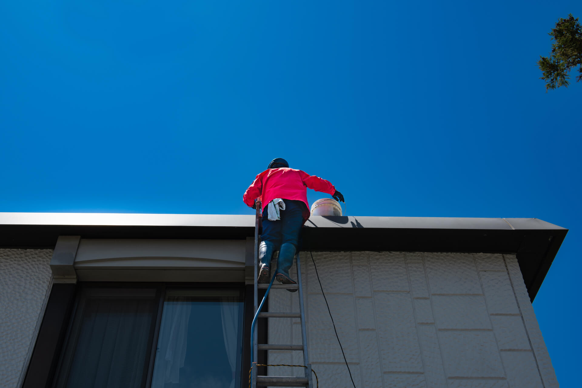 Professional roof inspector checking a residential flat roof condition in Calgary
