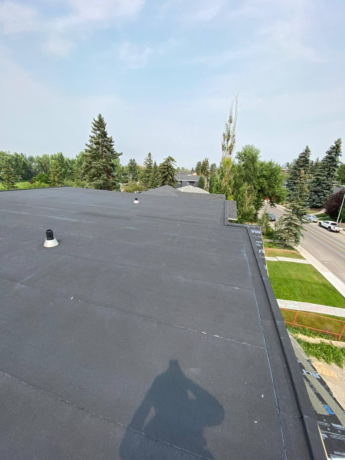 Residential flat roof repair work being performed on a Calgary home